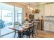 Cozy dining area with a wooden table, stylish decor, and access to the outdoor patio at 11702 Tetrafin Dr, Riverview, FL 33579