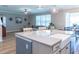 Spacious kitchen with gray countertops, a farmhouse sink, and an open view to the living room at 11702 Tetrafin Dr, Riverview, FL 33579