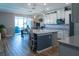 Bright kitchen with gray countertops, a center island, and modern appliances overlooking the dining area at 11702 Tetrafin Dr, Riverview, FL 33579