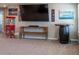Comfortable living room featuring a large TV, custom console, and stylish barrel table for entertainment at 11702 Tetrafin Dr, Riverview, FL 33579