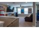 The living room features a large TV, comfortable seating, and ample natural light through the bright windows at 11702 Tetrafin Dr, Riverview, FL 33579