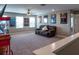 A casual living room with large windows and a big sofa at 11702 Tetrafin Dr, Riverview, FL 33579