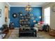 Stylish living room featuring blue accent wall, bookshelves, and comfortable seating at 11702 Tetrafin Dr, Riverview, FL 33579