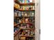 Walk-in pantry with wooden shelves stocked with food and supplies, offering ample storage at 11702 Tetrafin Dr, Riverview, FL 33579