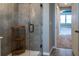 Elegant bathroom with a glass shower, tiled walls and wooden corner shelf for storage at 11702 Tetrafin Dr, Riverview, FL 33579