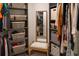 Walk-in closet featuring shelving, storage baskets and a bench with a mirror for convenience at 11702 Tetrafin Dr, Riverview, FL 33579