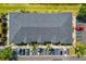 Aerial view of a three unit condo complex with dark roof and ample parking at 12971 Tigers Eye Dr, Venice, FL 34292