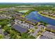 Aerial view of condos next to a lake with mature landscaping at 12971 Tigers Eye Dr, Venice, FL 34292