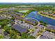 Aerial view of condos next to a lake with mature landscaping at 12971 Tigers Eye Dr, Venice, FL 34292