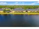 Exterior view of yellow condos next to a lake and surrounded by trees at 12971 Tigers Eye Dr, Venice, FL 34292