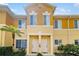 Exterior of yellow condos with white door frames and landscaping at 12971 Tigers Eye Dr, Venice, FL 34292