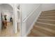 Hallway that features a stairway to the left and access to a 1/2 bath and living room at 12971 Tigers Eye Dr, Venice, FL 34292
