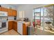 The kitchen offers a serene lake view from the sliding glass doors to the patio at 12971 Tigers Eye Dr, Venice, FL 34292