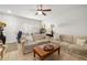 Bright living room featuring comfortable seating, tile floors and natural lighting at 12971 Tigers Eye Dr, Venice, FL 34292