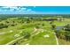 Scenic aerial view of the golf course, showcasing the lush green fairways, trees and ponds on a sunny day at 1330 Glen Oaks E Dr # 374D, Sarasota, FL 34232