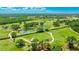 Beautiful aerial view of a vast golf course, lush greenery, small lakes, and clear blue sky at 1330 Glen Oaks E Dr # 374D, Sarasota, FL 34232