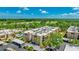 Aerial view of condo complex, pool, parking and lush landscaping at 1330 Glen Oaks E Dr # 374D, Sarasota, FL 34232
