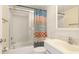 Bathroom with colorful shower curtain, vanity and shower and tub combo at 1330 Glen Oaks E Dr # 374D, Sarasota, FL 34232