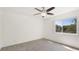 A bright bedroom with neutral carpet, ceiling fan and large window at 1330 Glen Oaks E Dr # 374D, Sarasota, FL 34232