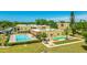 Exterior aerial view of condo building with swimming pool and shuffleboard at 1330 Glen Oaks E Dr # 374D, Sarasota, FL 34232