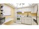A kitchen featuring white cabinets, appliances, and tile floors at 1330 Glen Oaks E Dr # 374D, Sarasota, FL 34232