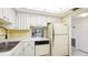 Cozy kitchen with double basin sink, white cabinets and vintage appliances at 1330 Glen Oaks E Dr # 374D, Sarasota, FL 34232