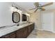 Bright bathroom features double vanity with marble countertop and decorative ceiling fan at 13615 4Th Ne Ave, Bradenton, FL 34212