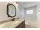 Bathroom featuring a granite vanity, dark cabinets, and a shower and tub combination at 13615 4Th Ne Ave, Bradenton, FL 34212