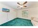 Bedroom with a ceiling fan, green carpet and flat screen TV at 13615 4Th Ne Ave, Bradenton, FL 34212