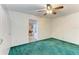 Bonus room that is open to the game room, featuring green carpet and white walls at 13615 4Th Ne Ave, Bradenton, FL 34212