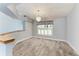 Cozy dining area with a stylish chandelier and shuttered window at 13615 4Th Ne Ave, Bradenton, FL 34212