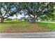 Charming single-story home featuring a well-manicured lawn, mature trees, and a traditional design at 13615 4Th Ne Ave, Bradenton, FL 34212