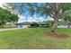 Inviting curb appeal with a well-maintained lawn, mature trees, and an attached two-car garage at 13615 4Th Ne Ave, Bradenton, FL 34212