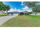 Charming single-story home with a well-maintained lawn and a three-car garage at 13615 4Th Ne Ave, Bradenton, FL 34212