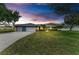 Charming single-story home with a well-manicured front yard, mature trees, and a spacious driveway at 13615 4Th Ne Ave, Bradenton, FL 34212
