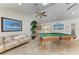 Relaxing game room includes a pool table, sofa, and flat screen television at 13615 4Th Ne Ave, Bradenton, FL 34212