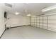 Large garage with bright lighting, ceiling fan, and door to the home's interior at 13615 4Th Ne Ave, Bradenton, FL 34212