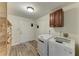 Laundry room with wooden shelf, laundry machine, and dryer at 13615 4Th Ne Ave, Bradenton, FL 34212