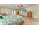 Bright main bedroom boasts hardwood floors, ceiling fan, and relaxing furniture at 13615 4Th Ne Ave, Bradenton, FL 34212