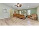 Main bedroom with wood floors, leafy ceiling fan and comfortable furnishings at 13615 4Th Ne Ave, Bradenton, FL 34212