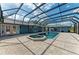 Beautiful screened-in pool area with large pool, spa, and brick paver deck at 13615 4Th Ne Ave, Bradenton, FL 34212