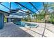 Screened-in pool and hot tub, surrounded by brick pavers and lush landscaping at 13615 4Th Ne Ave, Bradenton, FL 34212