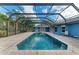 A spacious enclosed pool features a spa and a paved patio perfect for relaxing outdoors at 13615 4Th Ne Ave, Bradenton, FL 34212