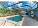 Relaxing pool with a screen enclosure and a spa, surrounded by patio pavers at 13615 4Th Ne Ave, Bradenton, FL 34212