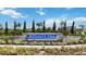Bungalow Walk at Waterside community entrance featuring lush landscaping and a decorative stone wall at 141 Thorne Ln, Sarasota, FL 34240