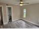 Serene bedroom with light, bright walls, tile floors, and an adjacent bathroom at 1654 Blakemore Ln, Sarasota, FL 34231