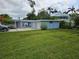 Charming blue home with a well-manicured lawn and attached two-car garage at 1654 Blakemore Ln, Sarasota, FL 34231