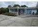 Inviting covered front porch featuring lovely landscaping and seating at 1654 Blakemore Ln, Sarasota, FL 34231