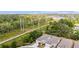 An aerial view shows the new home community, adjacent to a green space with tall power lines at 1800 Little Bird Ct, Sarasota, FL 34235