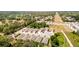 An aerial view of houses with mature trees and powerlines surrounding the properties at 1800 Little Bird Ct, Sarasota, FL 34235